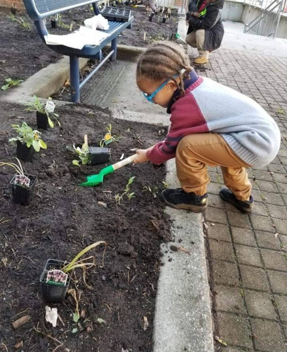 Coit CAA - Students planting with trowel